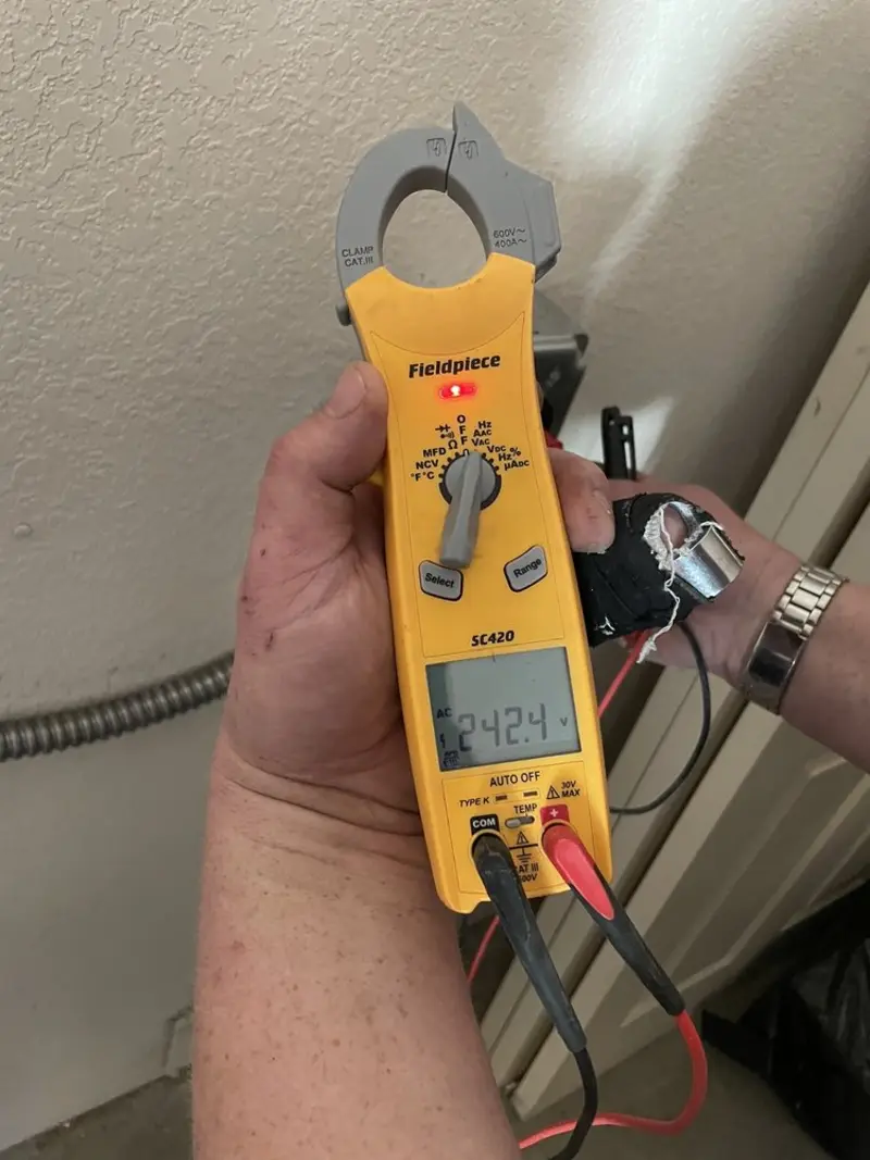 Voltage testing with clamp meter during Outlet Installation in Louisburg
